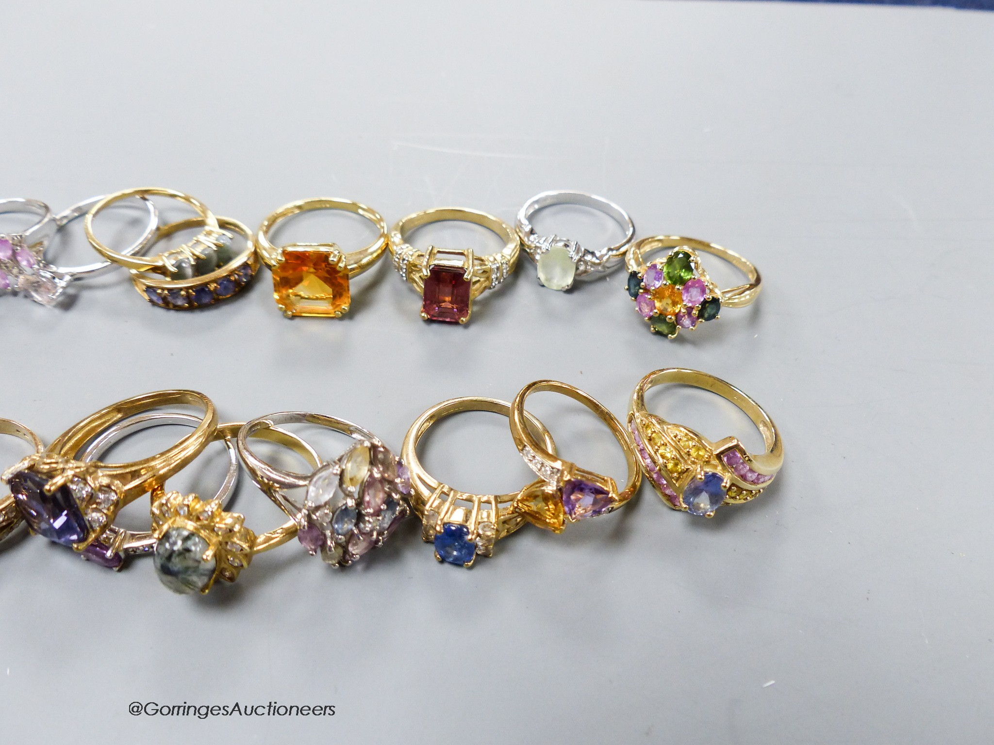 Twenty assorted modern 9ct or 9k and gem set dress rings, gross 65.5 grams.